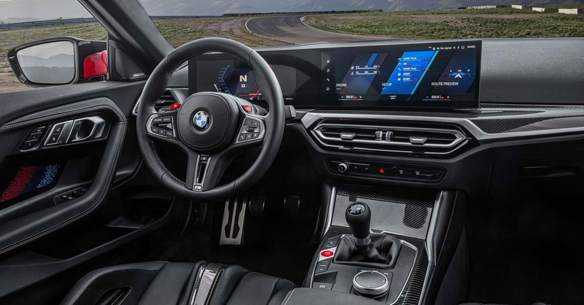 An image of the 2023 BMW M2 Coupe showing the steering wheel and front dashboard