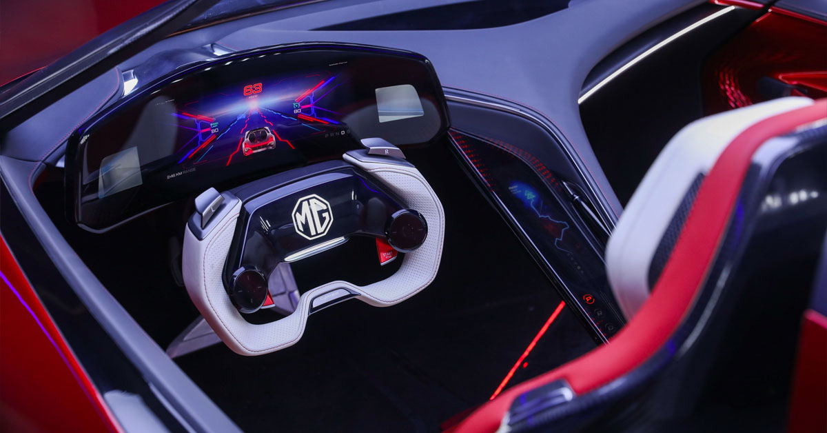 An image of the interior of the 2024 MG Cyberster Roadster EV showing the steering wheel and three cockpit screens