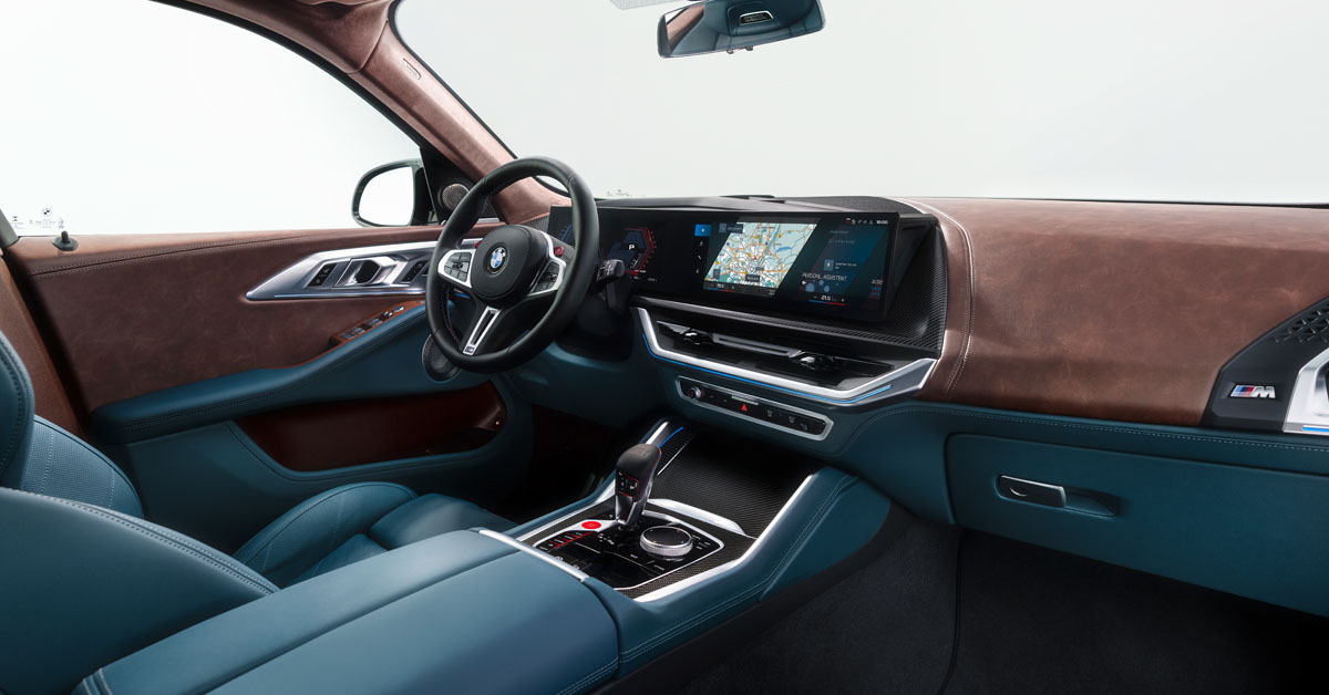 An image of the 2023 BMW XM Hybrid SUV showing the front dashboard area and steering wheel