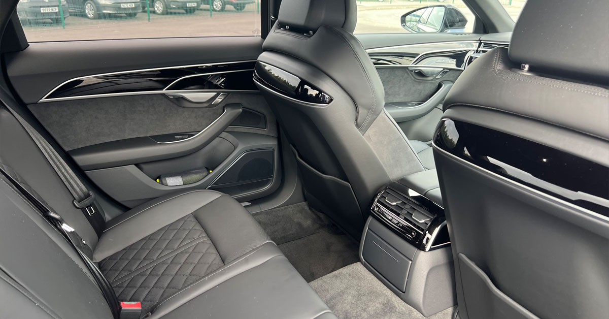 An image of a 2022 Audi A8 Saloon from the interior back seat